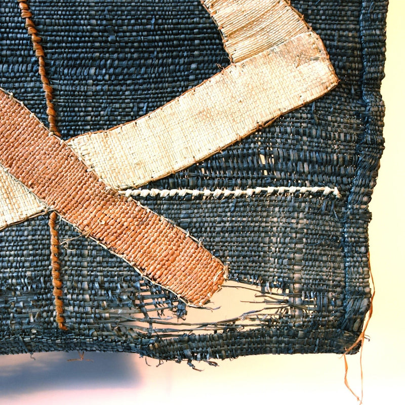 Denim colored cloth with brown and cream criss cross pattern, close up