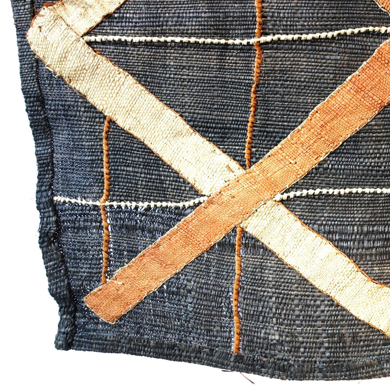 Denim colored cloth with brown and cream criss cross pattern, close up