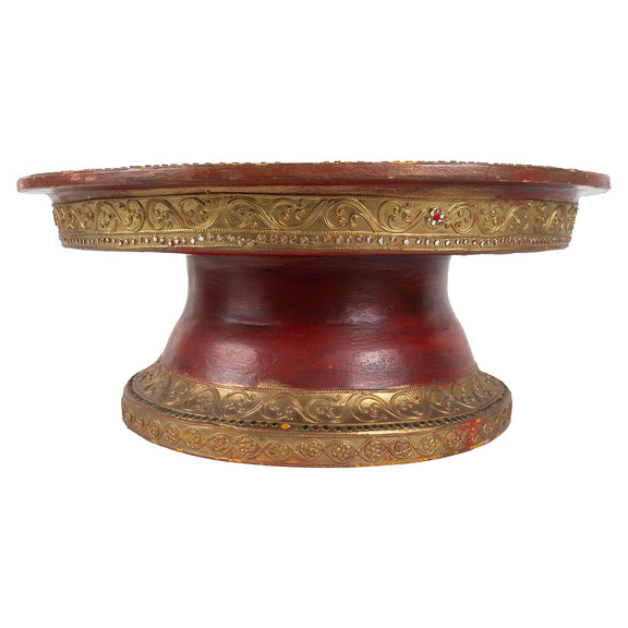 Red pedestal shaped offering basket with gold trim, side view