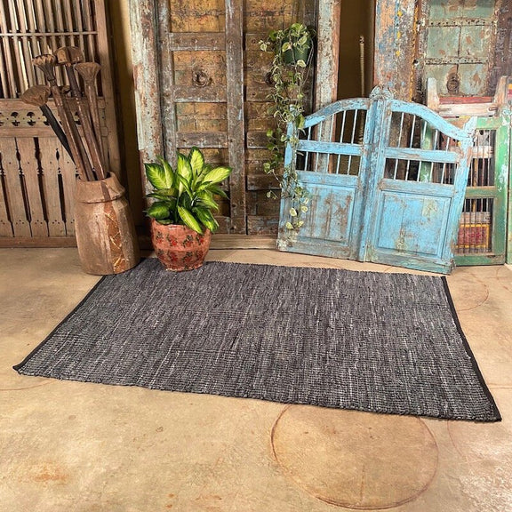 Handwoven grey/blue colored cotton and leather rug