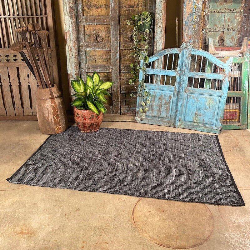 Handwoven grey/blue colored cotton and leather rug