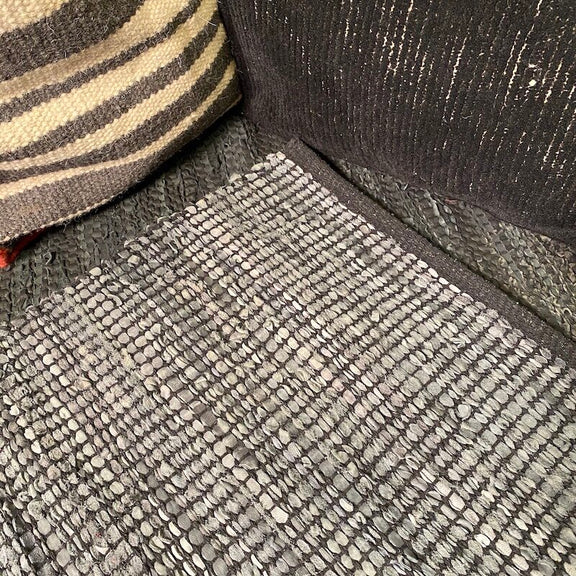 Handwoven cotton and leather rug, close up