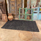 Hand woven black leather and cotton rug