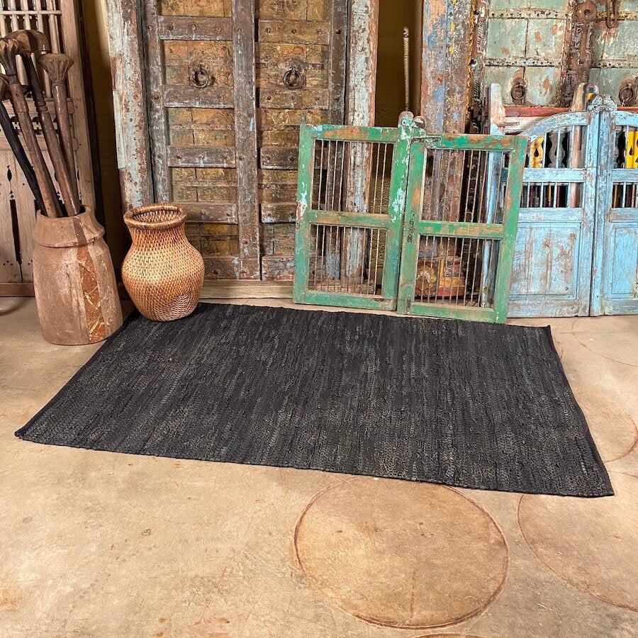 Hand woven black leather and cotton rug